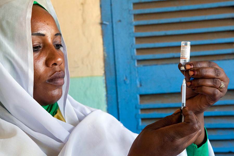 woman holding meningitis vaccine