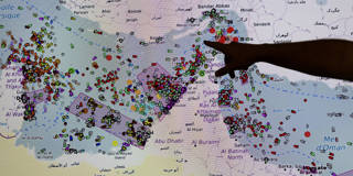 French naval officer Thomas Scalabre points to a screen showing ship positions in the Strait of Hormuz at the MICA maritime security center in Brest, France, where sailors monitor global maritime hotspots in real time, including the Persian Gulf amid heightened tensions following the 2026 Middle East conflict.