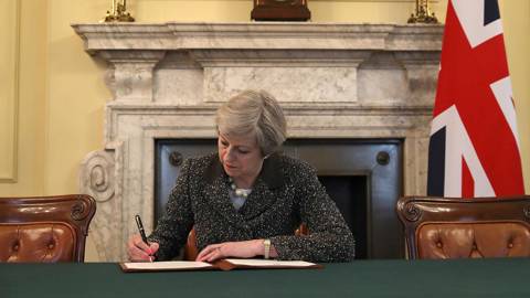 Theresa May signs the official letter to European Council President Donald Tusk, invoking Article 50 