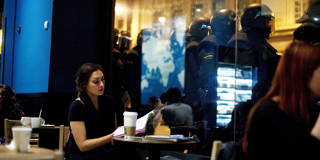 A student sits in a cafe during a protest