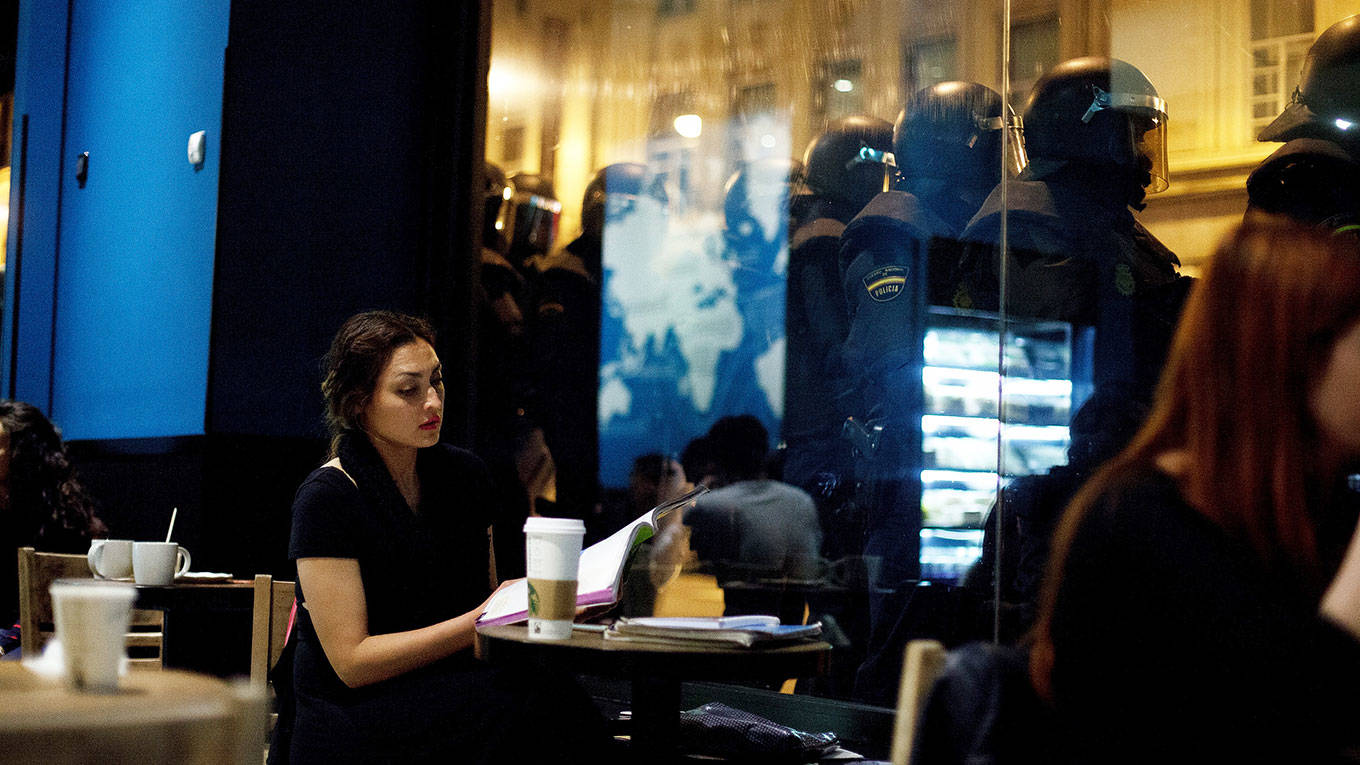 A student sits in a cafe during a protest