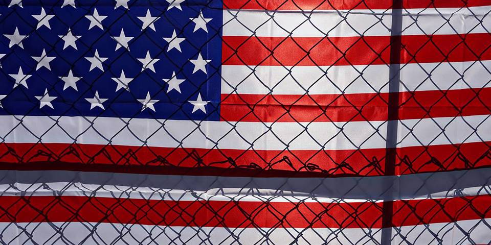 eichengreen138_SANDY HUFFAKERAFP via Getty Images_americanflagfence