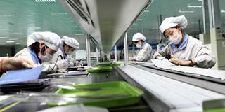 Employees work on a solar panel production line at Shenzhou New Energy Co