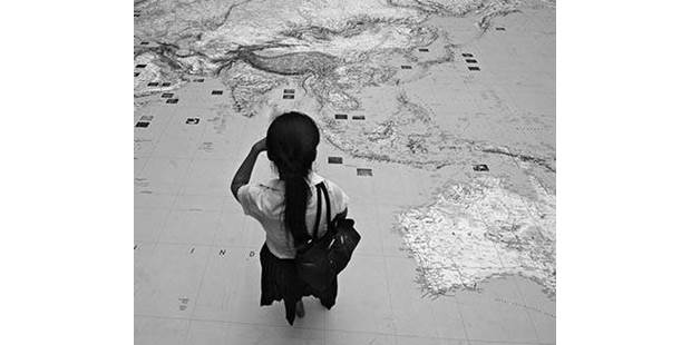 Woman looking asia map