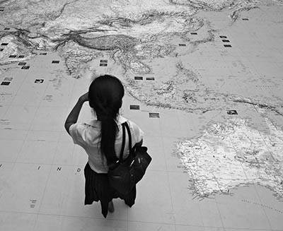 Woman looking asia map