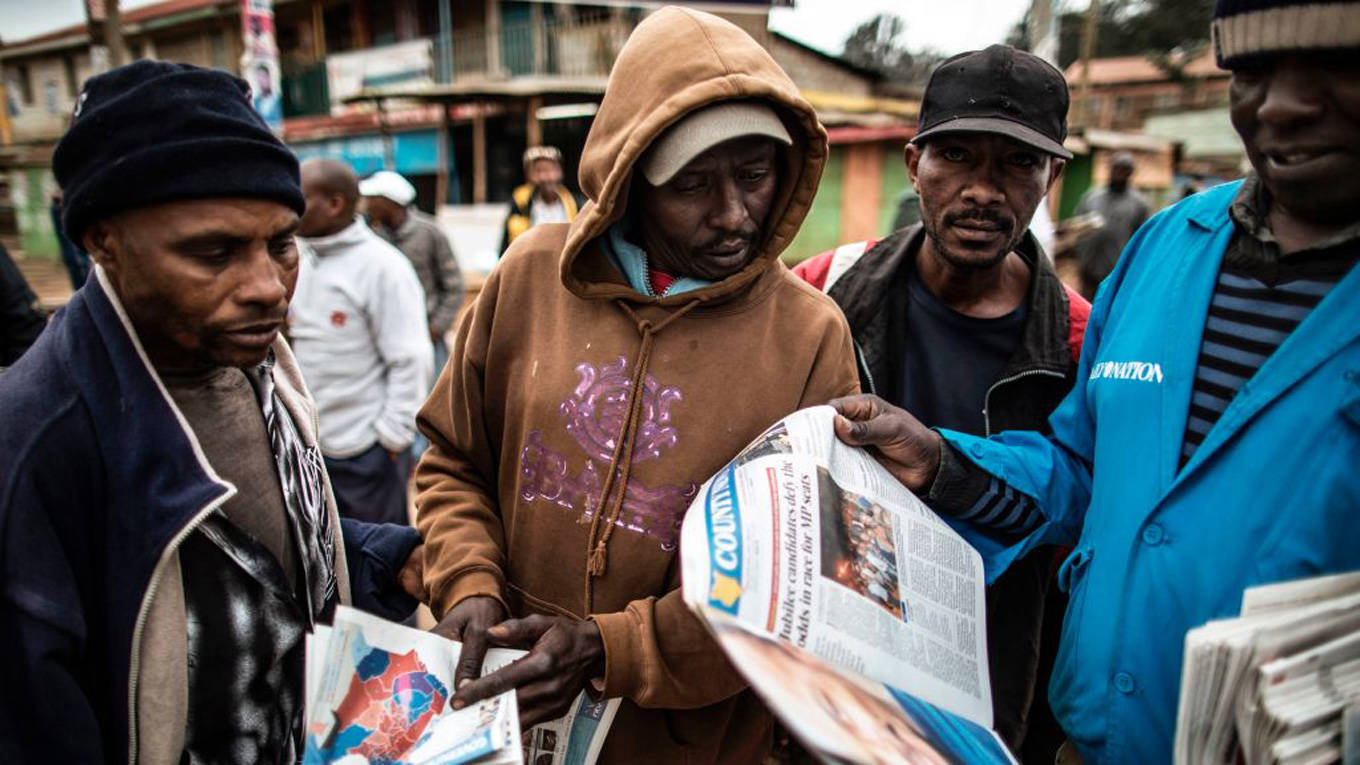 men reading newspapers kenya