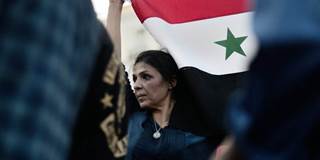 Woman carrying flag of Syria