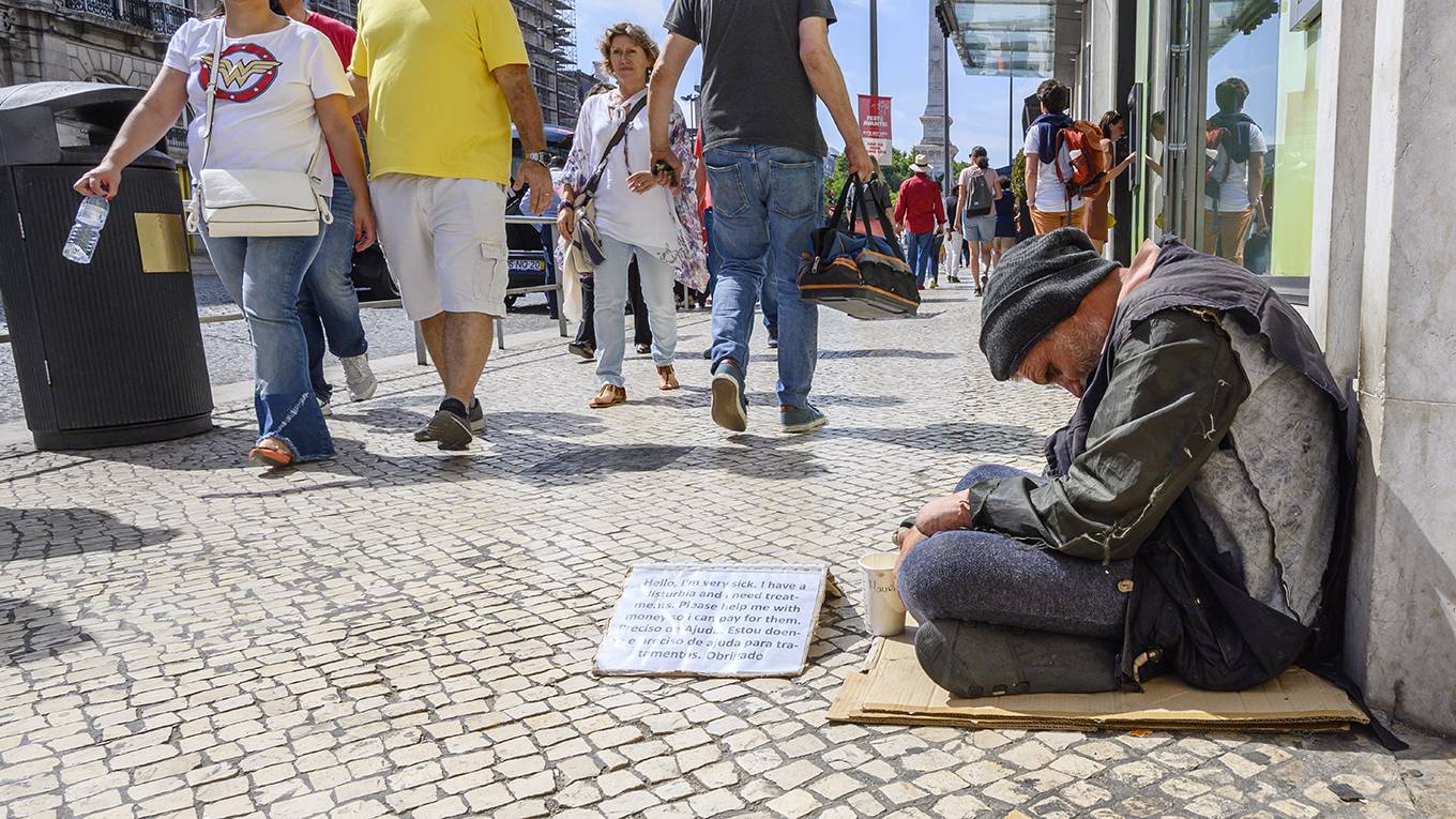 mohieldin27_HoracioVillalobosCorbisviaGettyImages_homelessmanpplwalkingby