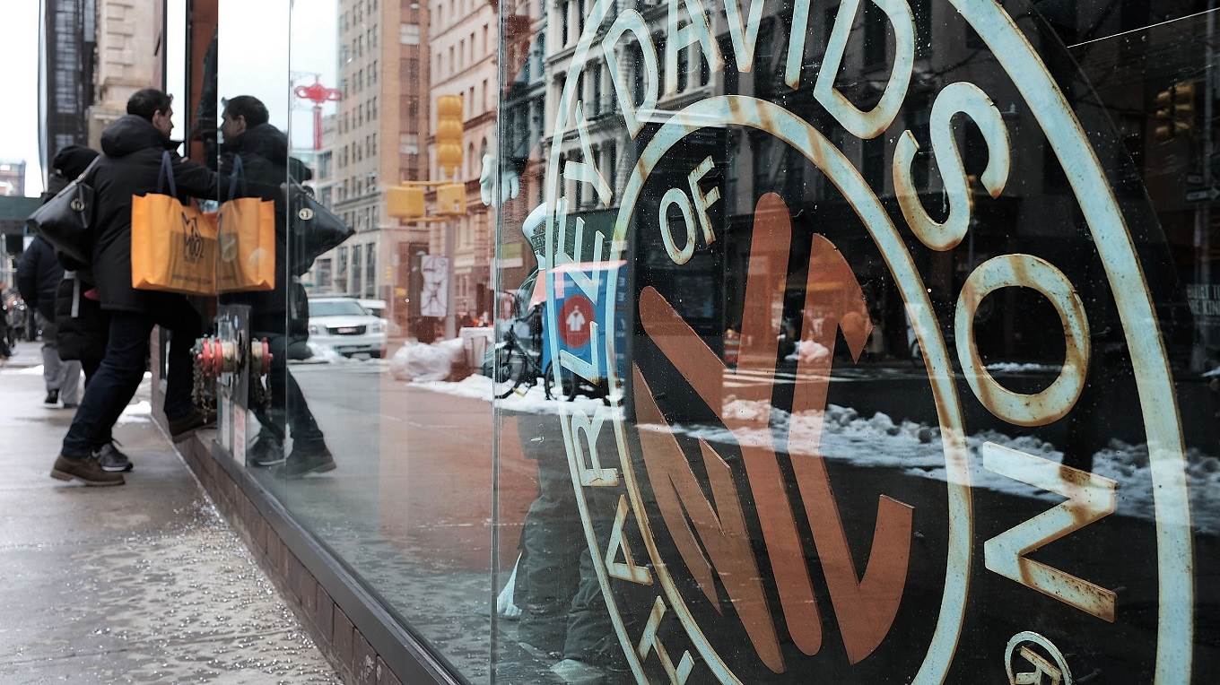 A Harley Davidson sign is displayed in a window at the New York store 