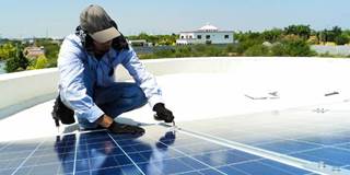 Man installing photovoltaic panels