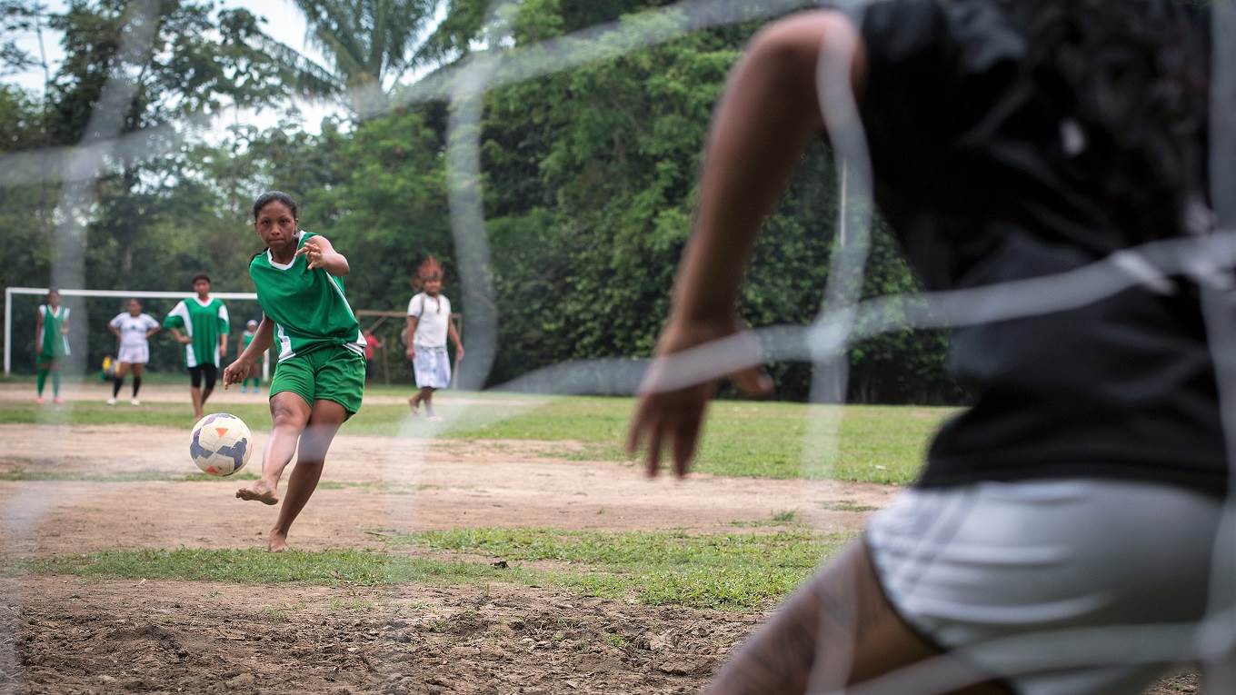A member of the Satere Mawe tribe shoots at the goal