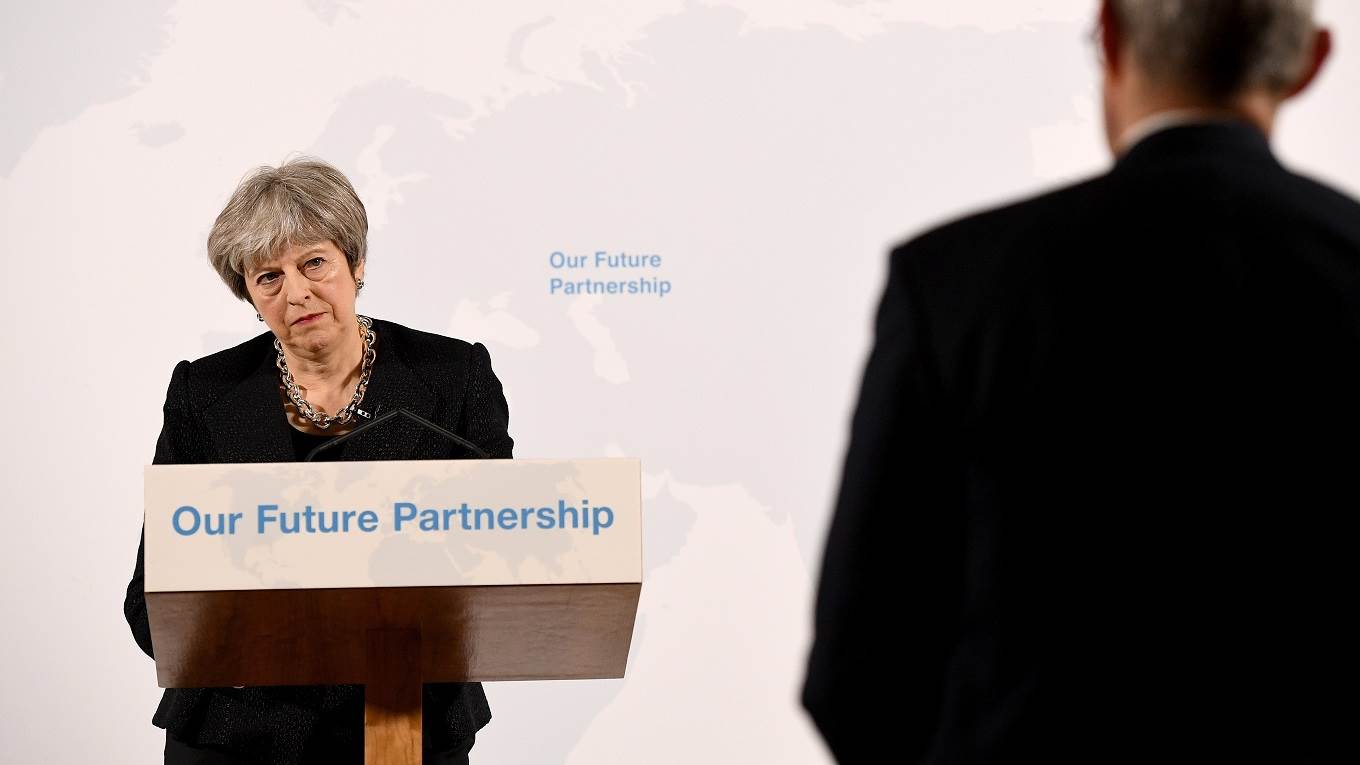 Theresa May listens to a question from the audience after giving a speech on Brexit