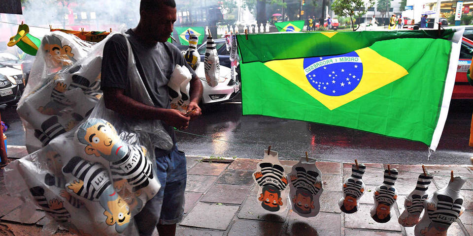 A vendor sells inflatable dolls depicting former Brazilian president Luiz Inacio Lula da Silva 