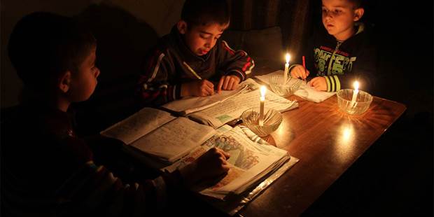 Studying by candle light in Gaza