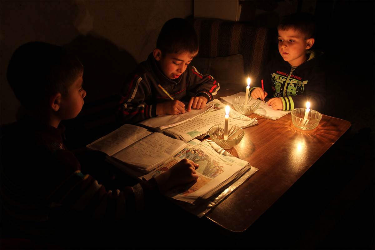 Studying by candle light in Gaza