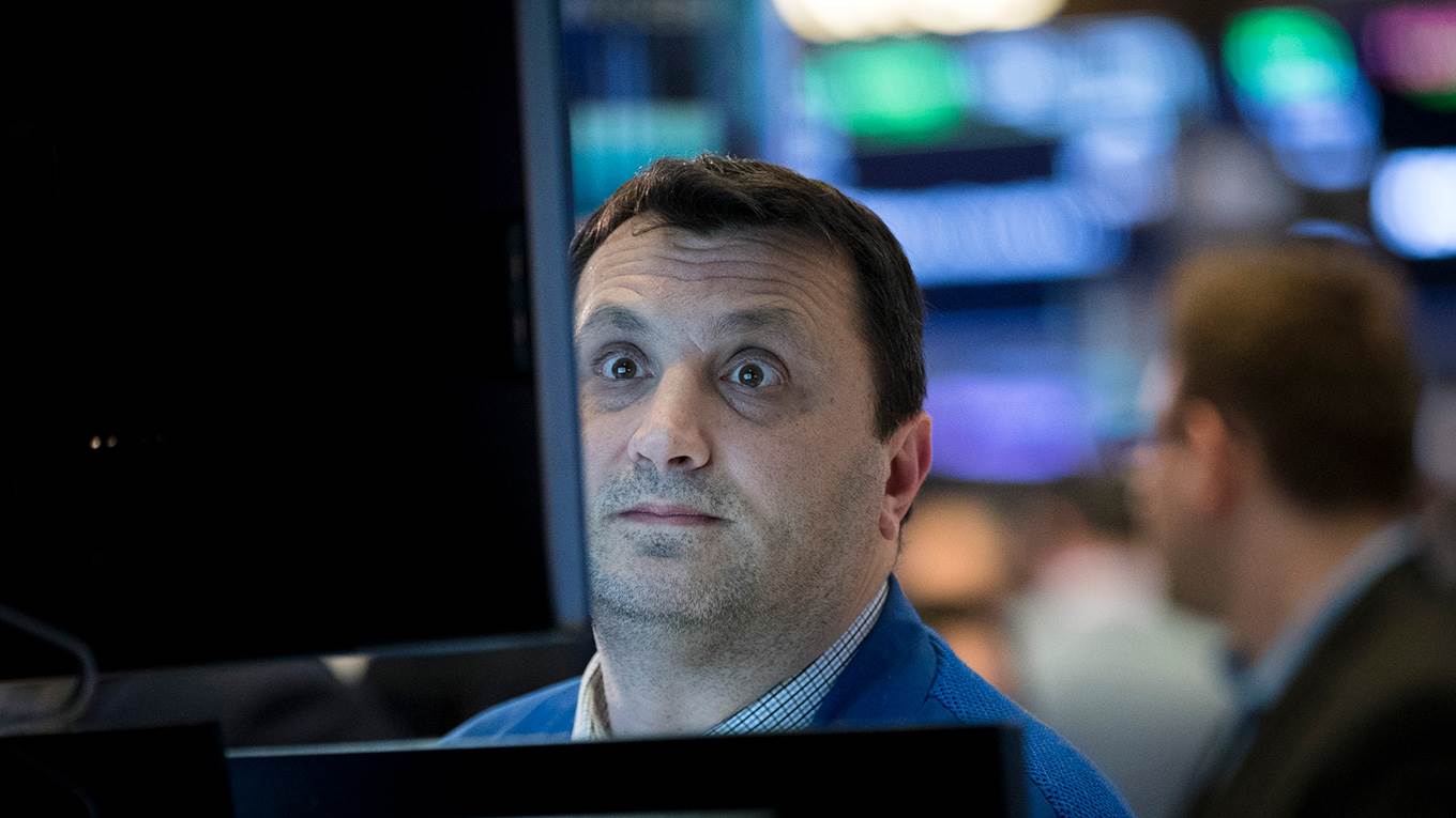Financial professionals work on the floor of the New York Stock Exchange