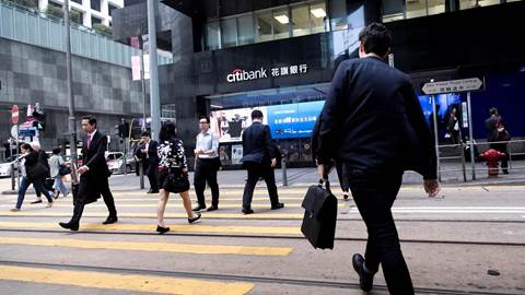 Managers go to work in the Central area in the financial center in Hong Kong