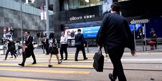Managers go to work in the Central area in the financial center in Hong Kong