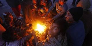 Indian day laborers around fire