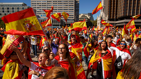 Demonstrators shout slogans and hold Spanish flags