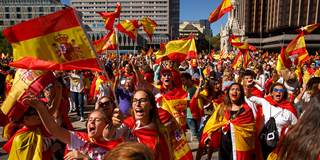 Demonstrators shout slogans and hold Spanish flags