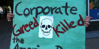 Corporate greed protest sign