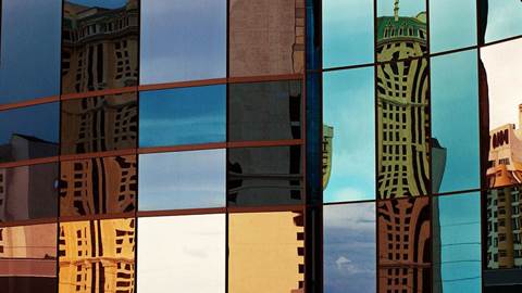 Skyscraper windows and city in reflection