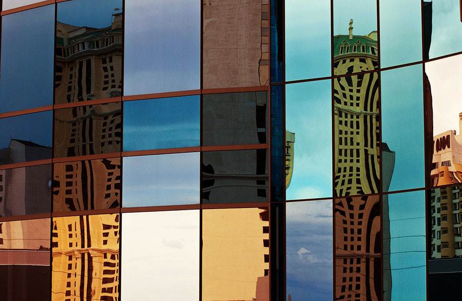 Skyscraper windows and city in reflection