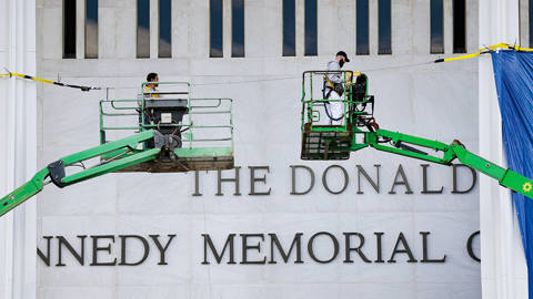Workers putting Trump's name on Kennedy Center.