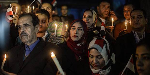 Egyptians hold candles at a vigil