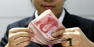 A Chinese clerk counts RMB