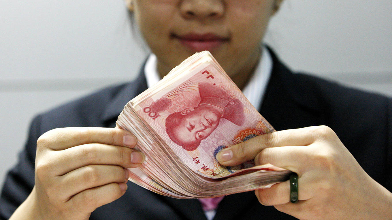A Chinese clerk counts RMB