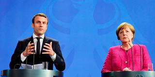 German Chancellor Angela Merkel and French President Emmanuel Macron address a joint press conference
