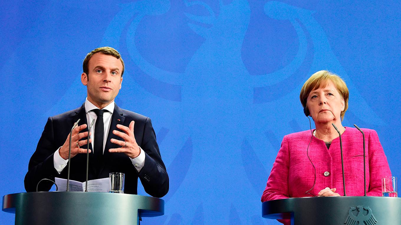 German Chancellor Angela Merkel and French President Emmanuel Macron address a joint press conference