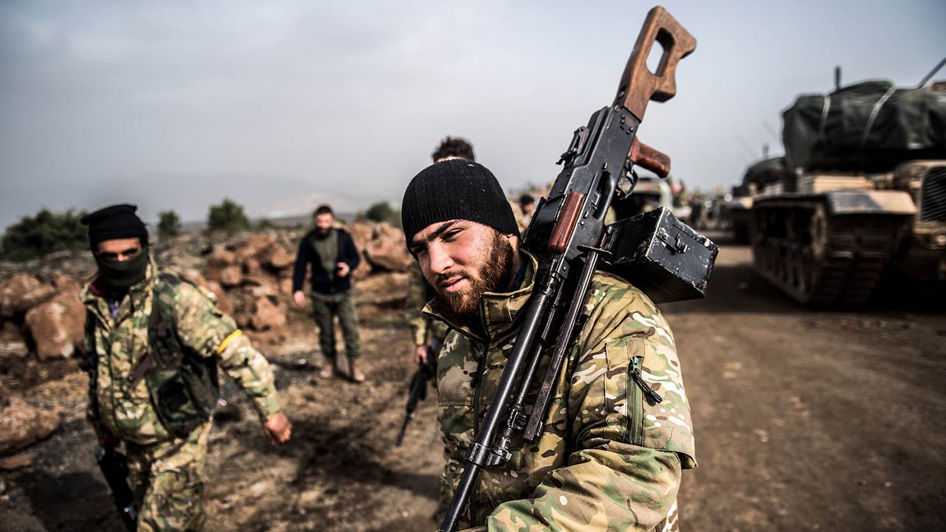 Turkish troops advance near the Syria border at Hassa