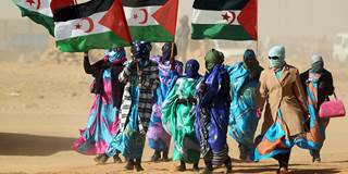 Sahrawi women hold Polisario Front's flags