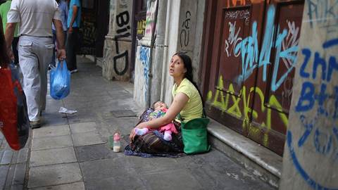 austerity woman sitting on street