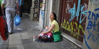 austerity woman sitting on street