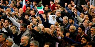 Iranian worshippers raise their fists