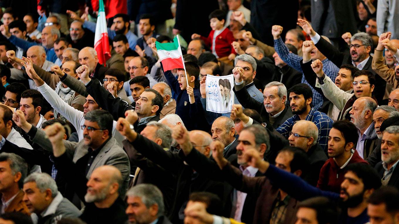 Iranian worshippers raise their fists