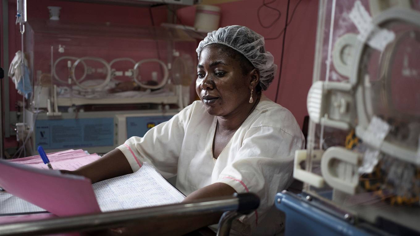 A nurse takes care of incubators at the premature baby ward of the pediatric hospital in Bangui