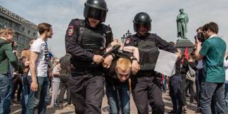 Russian Police forces seen arresting a protester during the demonstration