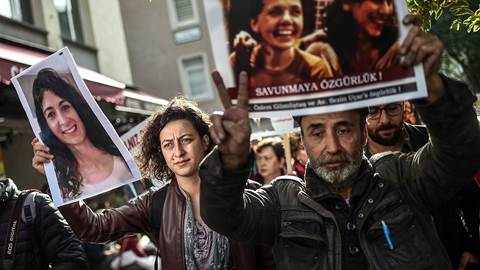 People hold pictures of jailed journalists in Turkey