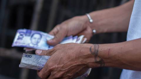 Pesos currency hands
