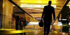 Man walks down the people mover in an airport