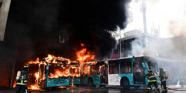adelman3_MARTIN BERNETTIAFP via Getty Images_chileprotestburningbus