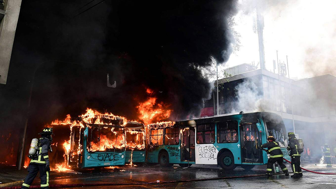 adelman3_MARTIN BERNETTIAFP via Getty Images_chileprotestburningbus