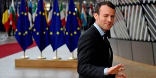  France's President Emmanuel Macron gestures as he arrives on the first day of a summit of EU leaders