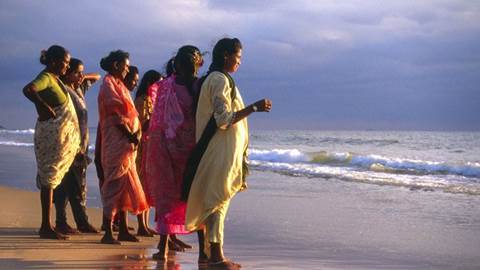 Indian women looking out over the ocean