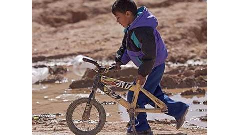 Syria refugee boy with bike